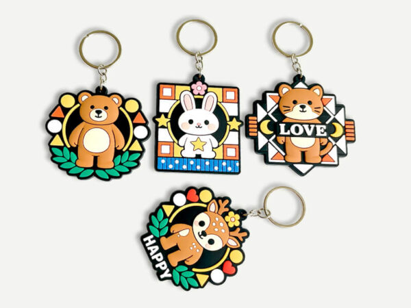 PVC vs silicone vs metal keychains comparison with a colorful molded PVC example