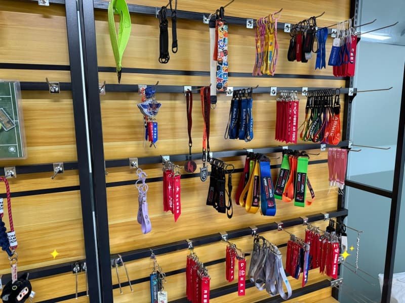 Assorted-custom-fabric-keychains-and-lanyards-displayed-on-wooden-shelving.jpg