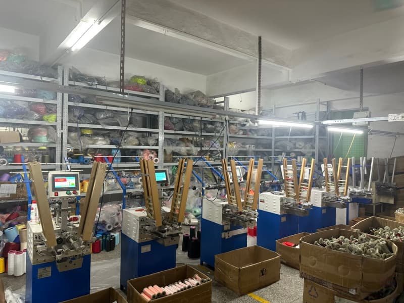 Automated-yarn-winding-machines-with-raw-materials-in-storage-area.jpg