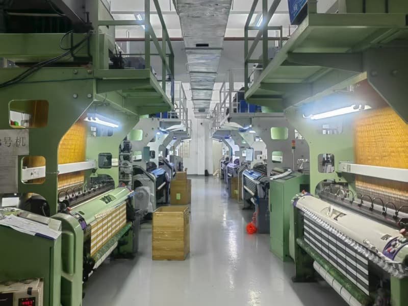 Large-scale-factory-workshop-with-advanced-weaving-machinery-for-production.jpg