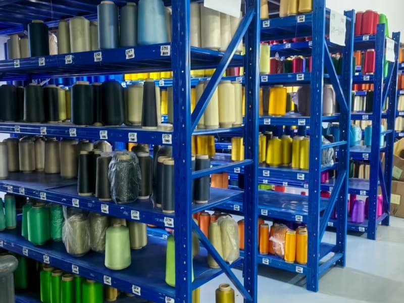 Vibrant-colored-yarn-spools-stored-in-organized-industrial-shelving-units.jpg