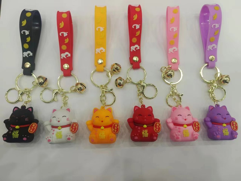 Colorful lucky cat PVC keychains with strap attachment options