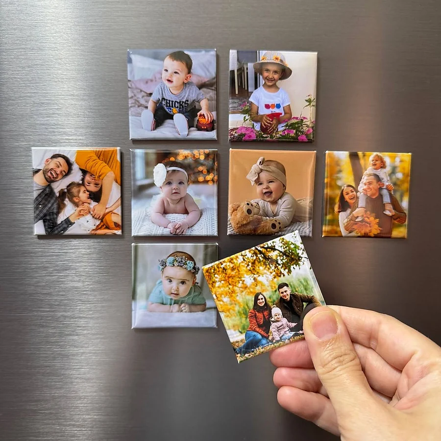Hand testing a custom photo fridge magnet on a steel refrigerator