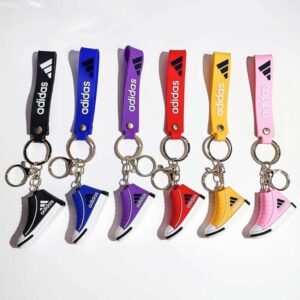 Adidas mini shoe keychains in six stock shades, each high-top sneaker hung from a matching printed wrist strap