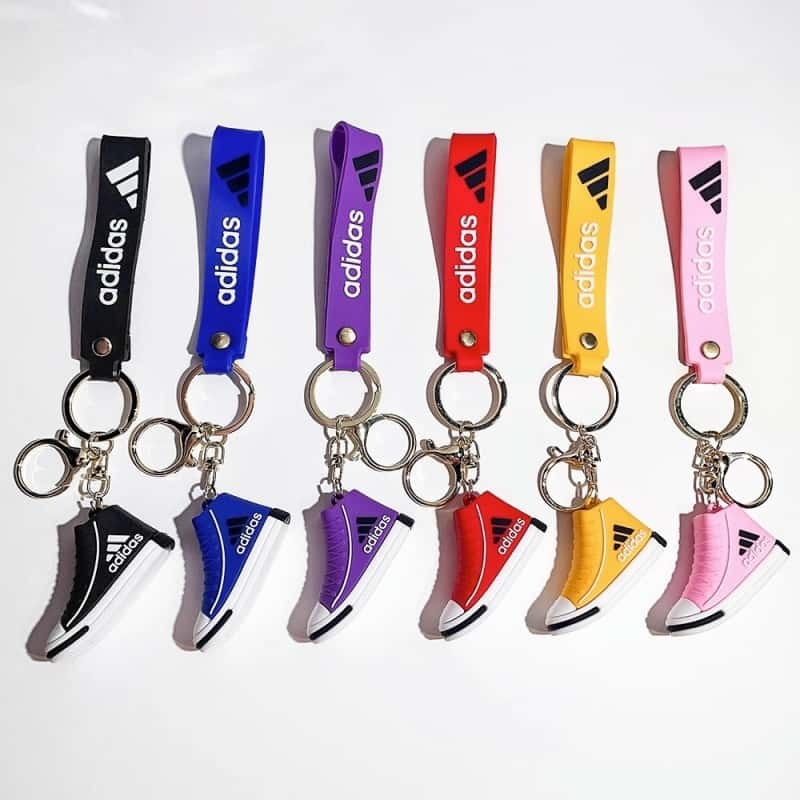 Adidas mini shoe keychains in six stock shades, each high-top sneaker hung from a matching printed wrist strap