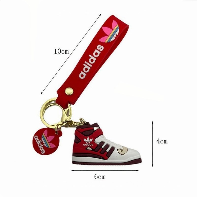 Adidas shoe keychain size chart: a 6 cm mini sneaker with a 10 cm tag strap measured against a ruler