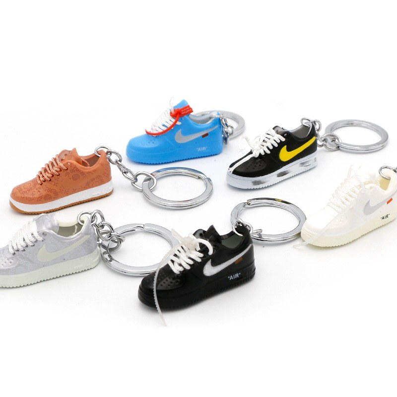 Air Force One shoe keychains in assorted shades lined up and counted against the packing list