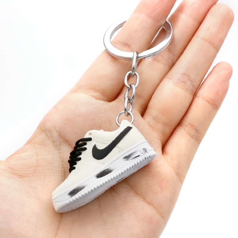 Air Force One shoe keychain in white PVC held by its split ring, showing the chain and the moulded sole