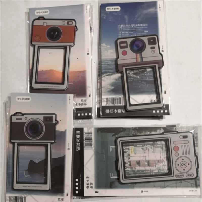 Camera fridge magnets packed for retail in boxes and bags