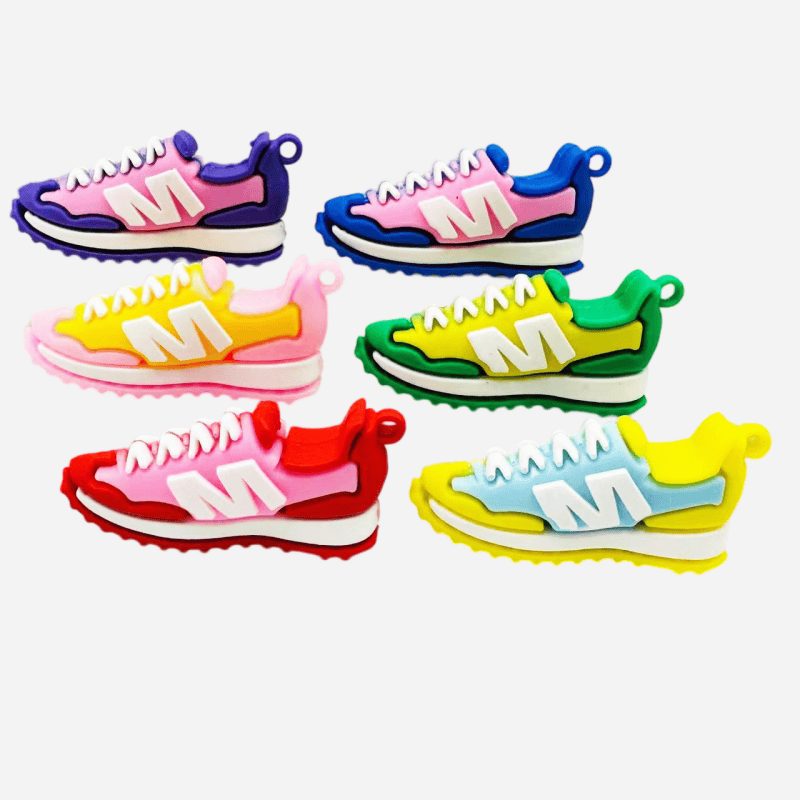 PVC sneaker keychains cut out on a light background showing the two-tone blocking