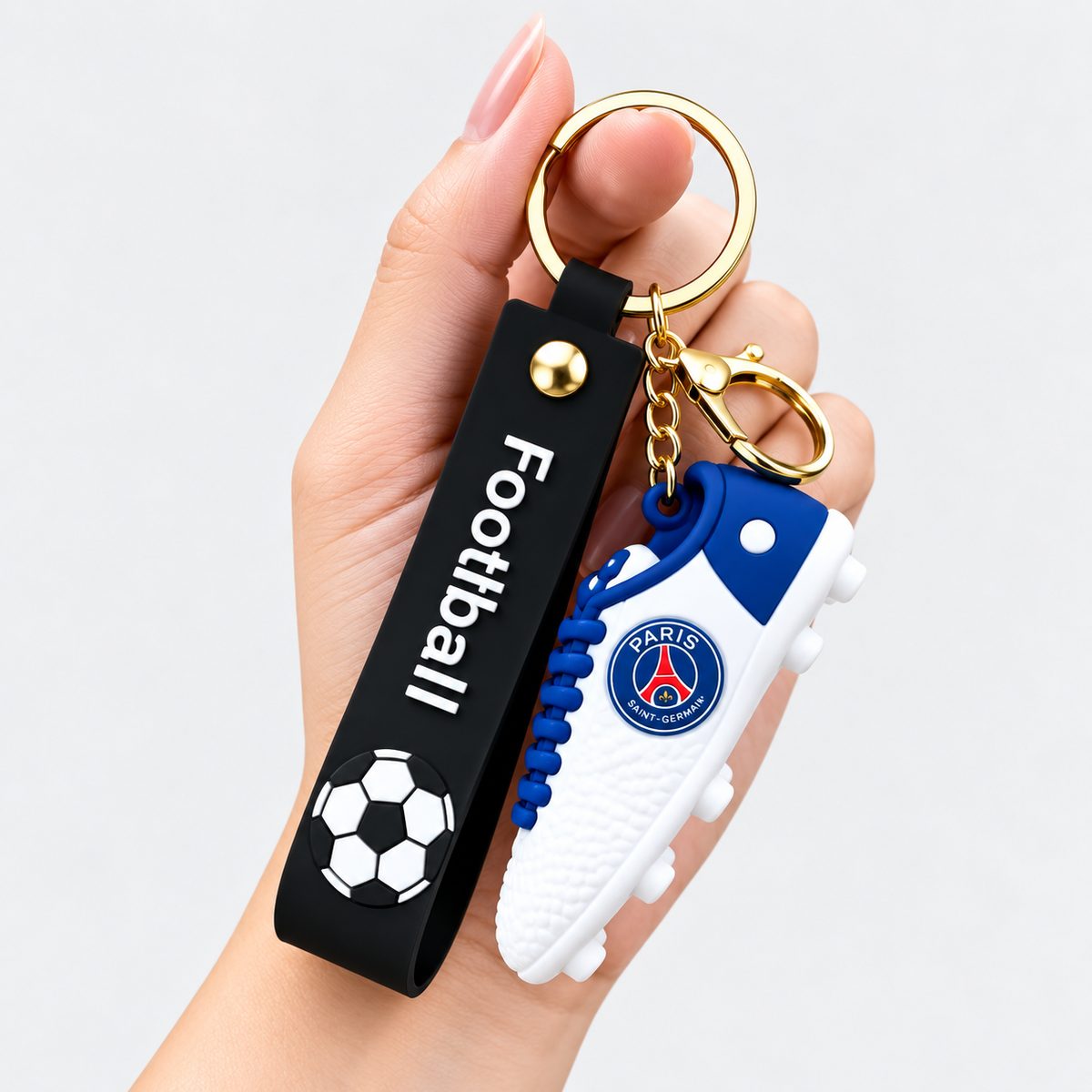 Navy blue football shoe keychain with club crest detail