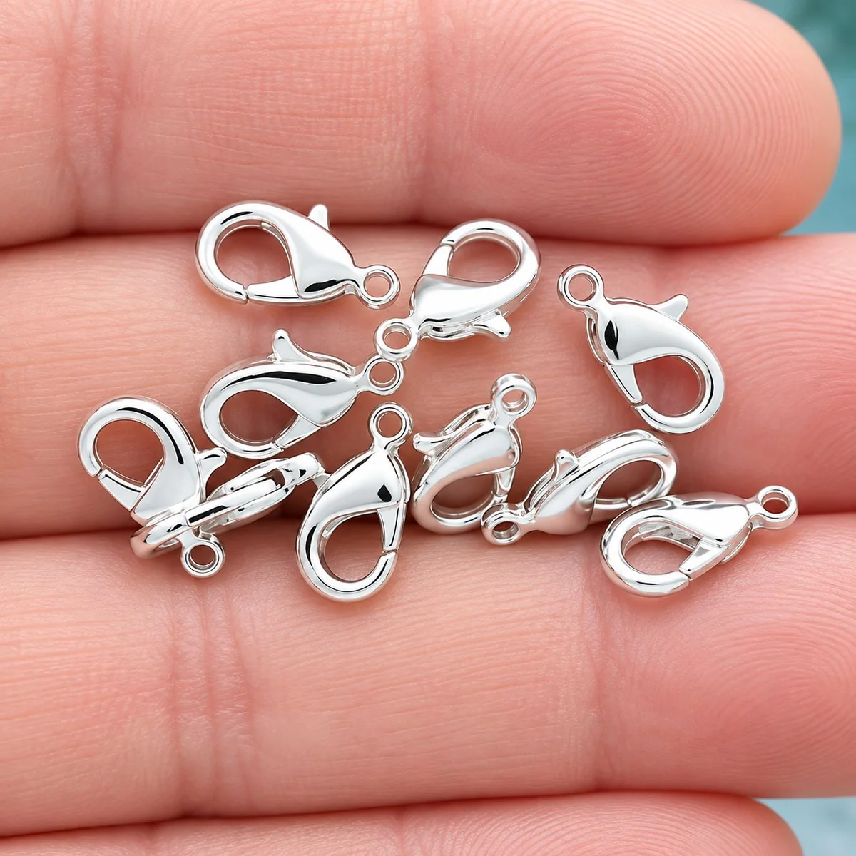 Lobster clasp: a silver spring-loaded gate clasp