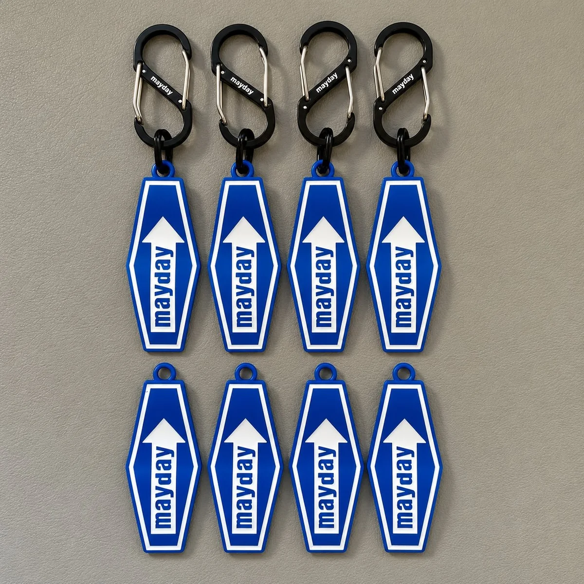 Blue motel-sign character PVC keychains — eight 'mayday' arrow tags in soft PVC