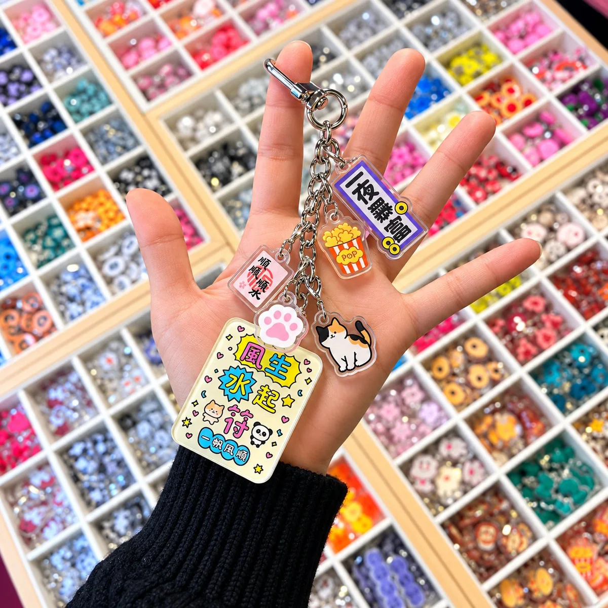Acrylic charm keychain: a handmade charm with Japanese-style graphics and a paw-print accent