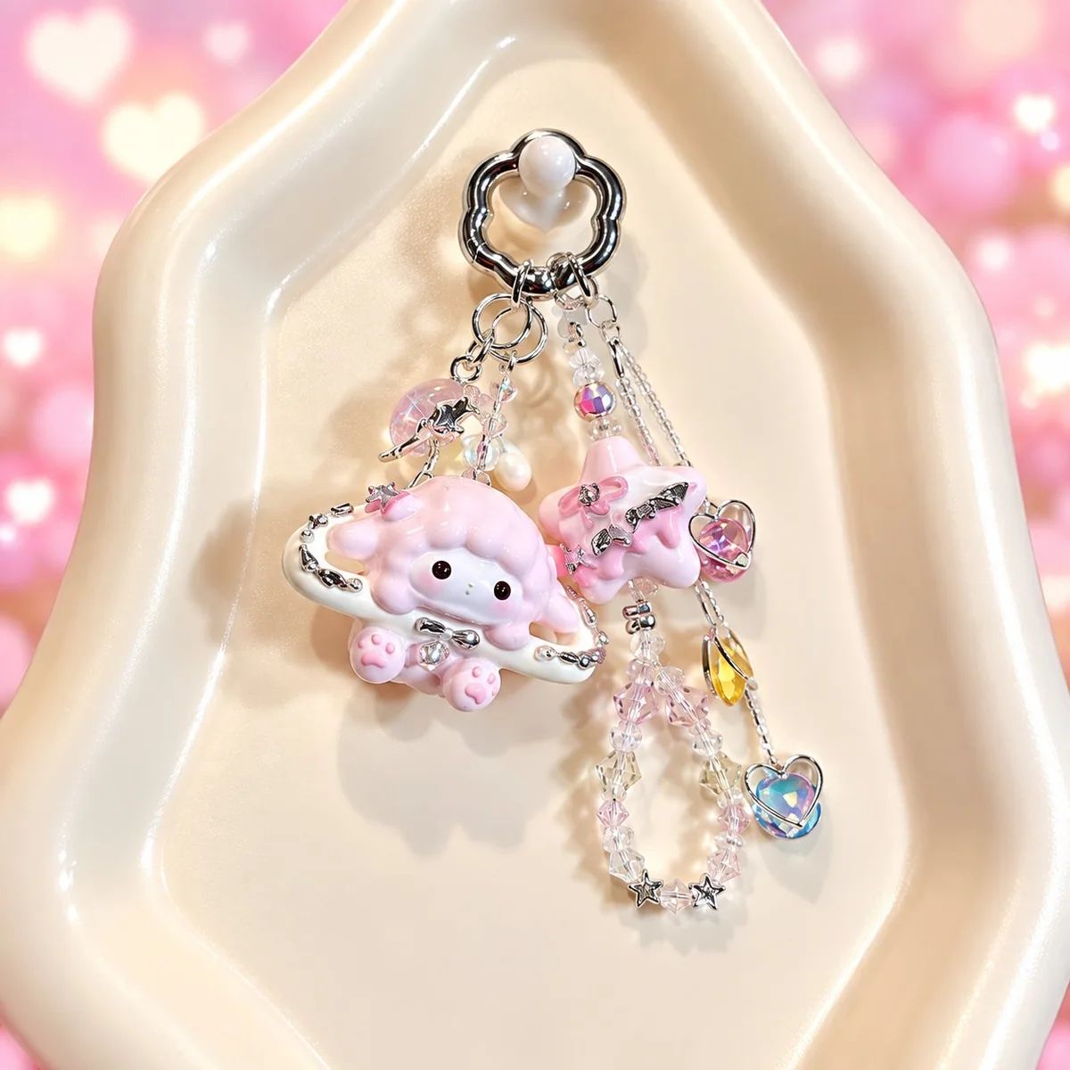 Resin bunny keychain: a sculpted character charm with dangling crystal accents on a flower-shaped clasp.