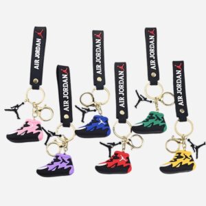 Six jordan keychain pieces in pink, purple, blue, red, green and yellow hanging together on a display board
