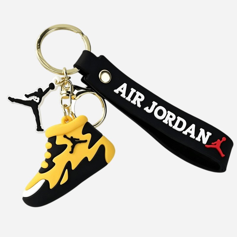 Jordan keychain in yellow and black showing the moulded eyelets, laces and splash pattern across the upper