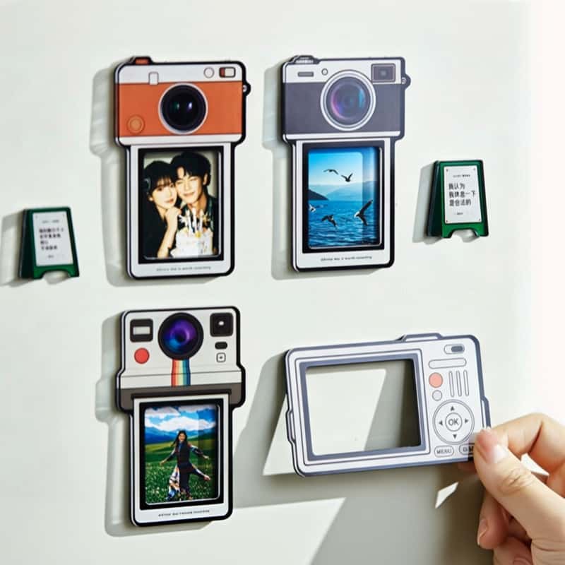 A print being seated into one of the retro camera fridge photo magnets