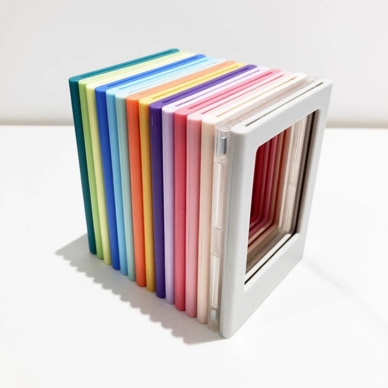 A row of magnetic picture frames stacked edge on, showing how slim the 6 mm ABS body is