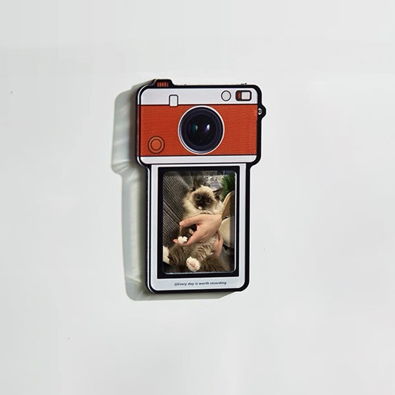 Orange camera photo magnet with a cat photo clamped in the frame