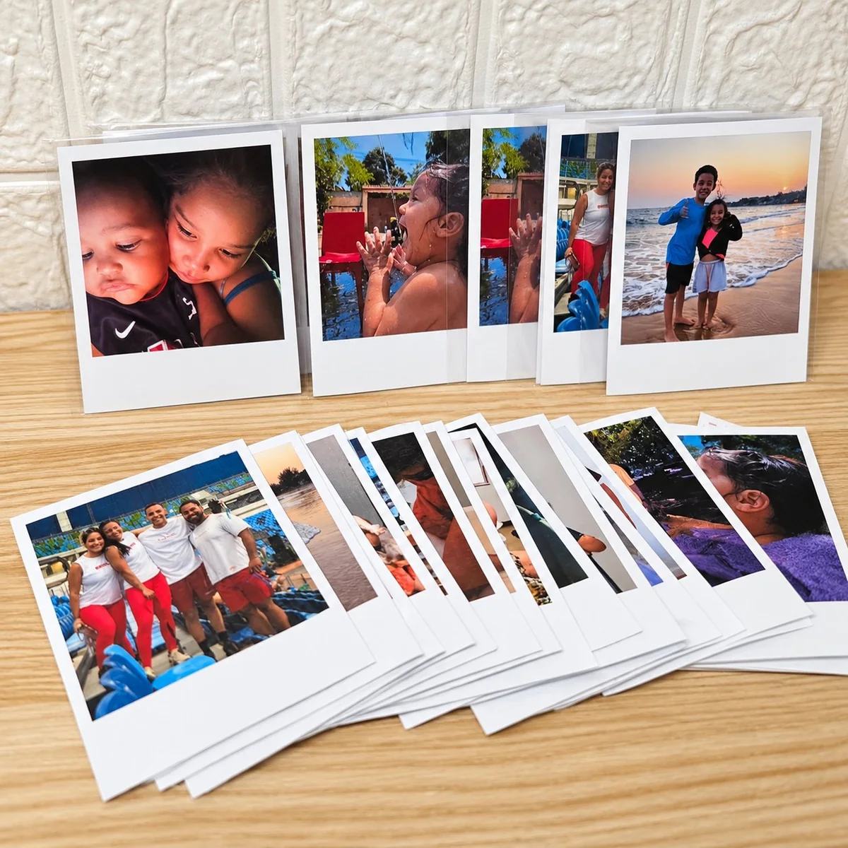 Family vacation 2024 Polaroid-style photo prints on a wooden surface