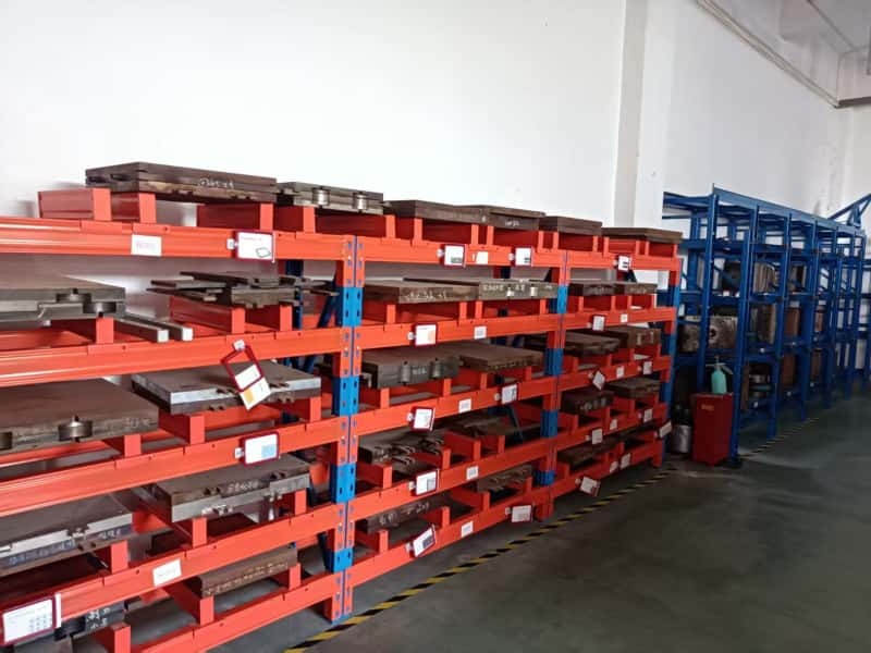 Mold storage racks holding finished rubber keychain tooling
