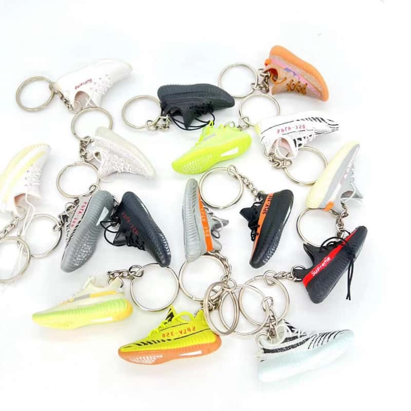 Miniature sneaker keychains in a range of models with their rings and straps, shown as an assembly reference