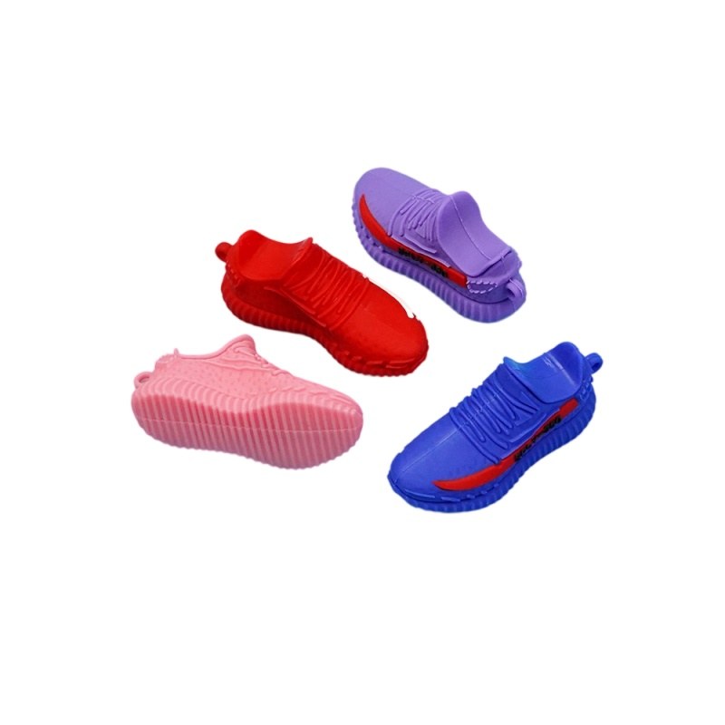 Yeezy shoe keychains in red, purple, pink and blue laid side by side for a shade comparison