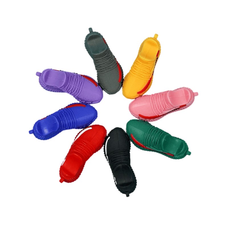 Yeezy shoe keychains fanned out by shade for the colour check before packing