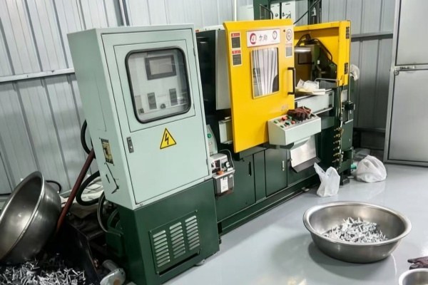 Die casting machine producing custom metal car keychains in bulk