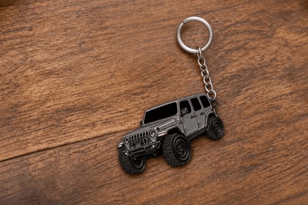 Finished custom metal SUV car keychain with a split ring on a wooden table