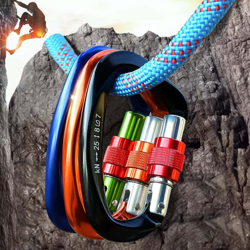 Carabiner keychains clipped to a climbing rope on a rock wall