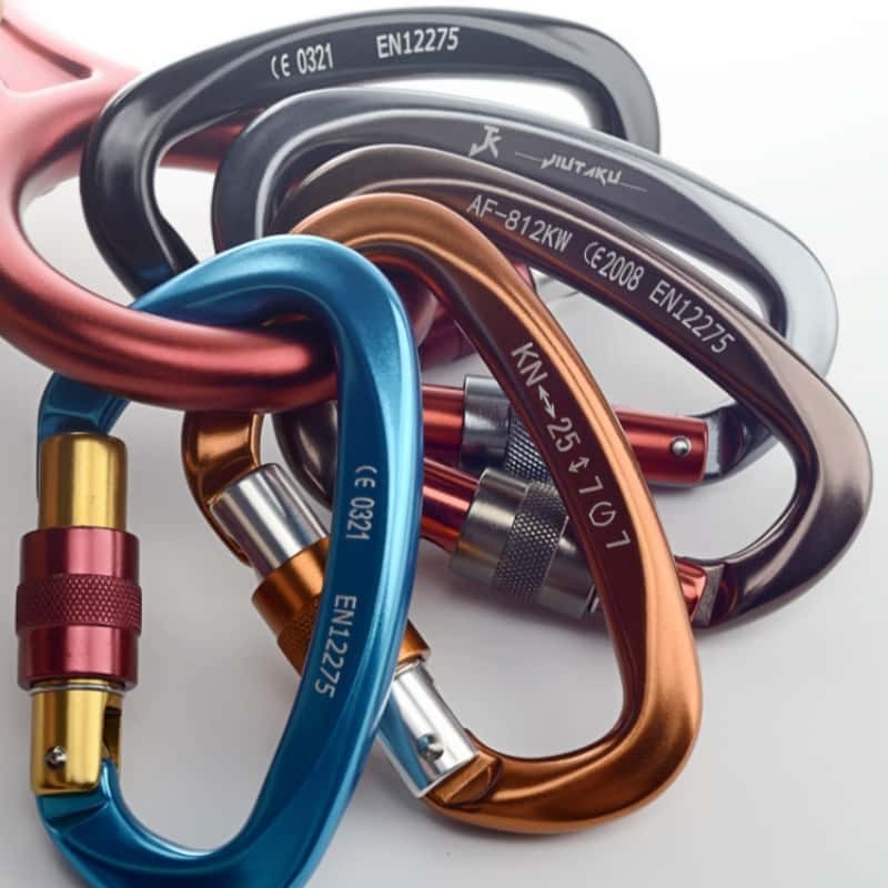 A pile of anodized carabiner keychains in mixed colors with EN12275 marking