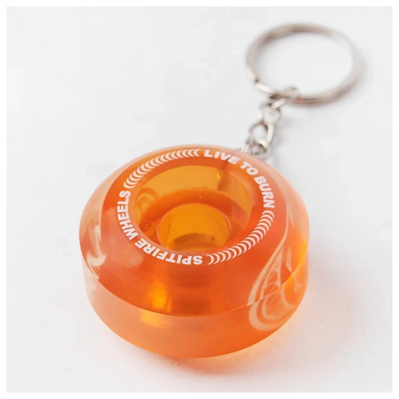 Close-up of a clear orange spitfire wheel keychain showing the printed sidewall and ring