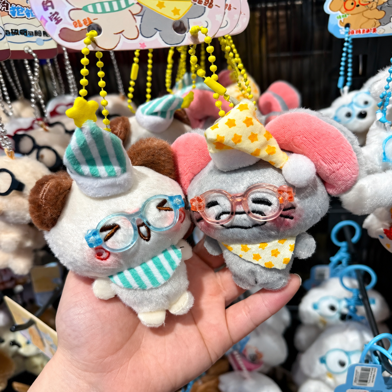 Soft plush character keychains with colorful glasses and hats