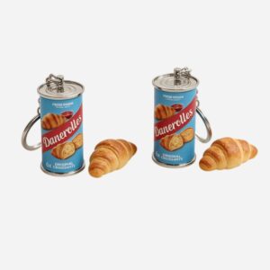 croissant can keychain clipped to a bag or keys