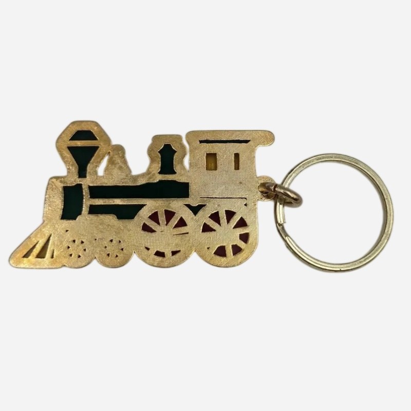Gold-plated back of the enamel train keychain showing the die-cast frame
