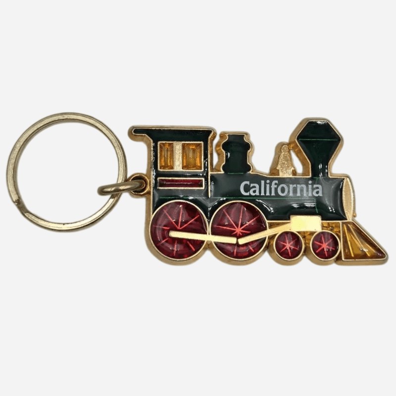 Enamel train keychain with green body, gold frame and red wheels, California edition