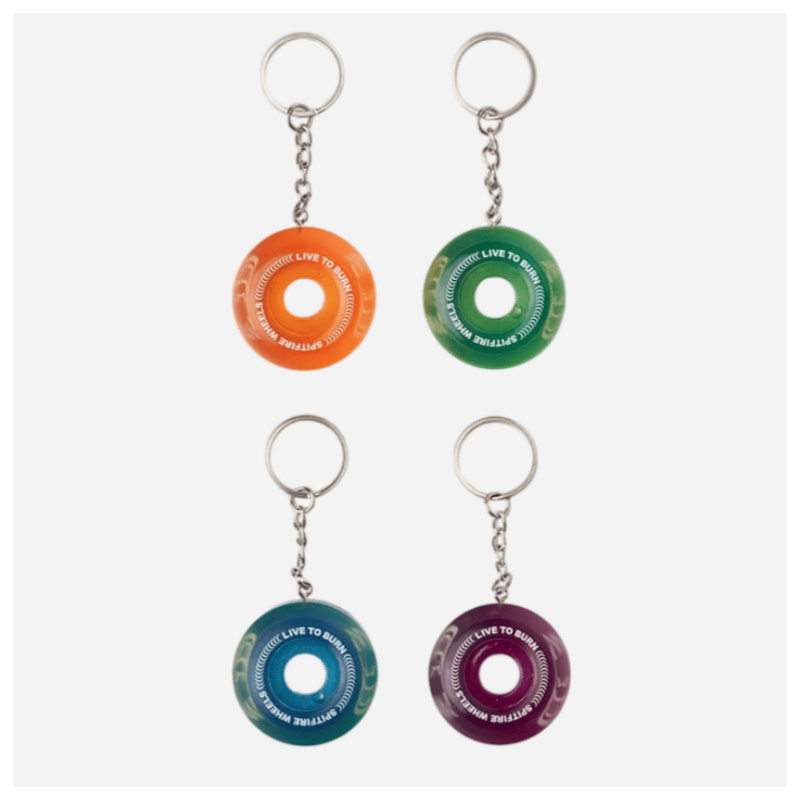 Four clear translucent spitfire wheel keychains laid out in a flat display