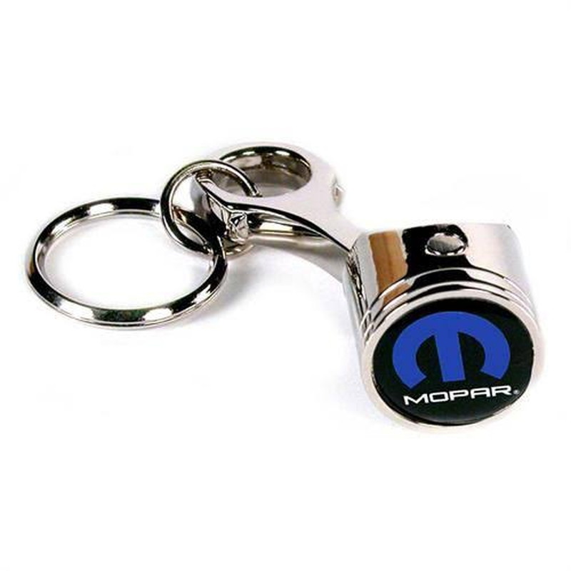 Metal piston keychain with a custom blue car brand logo on the round face