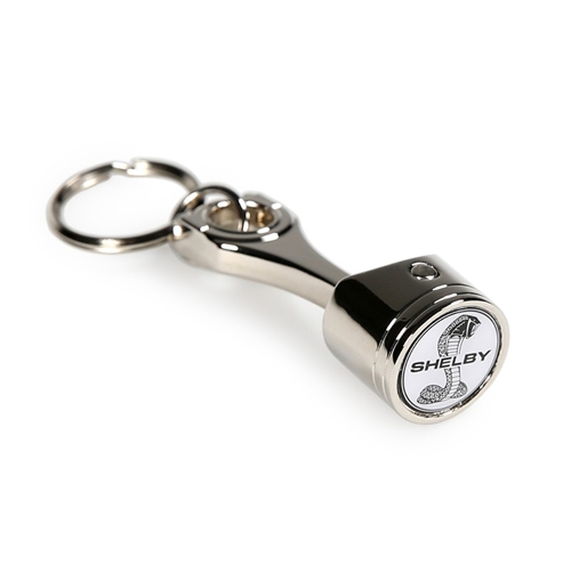 Chrome metal piston keychain with a custom cobra snake logo on the round face
