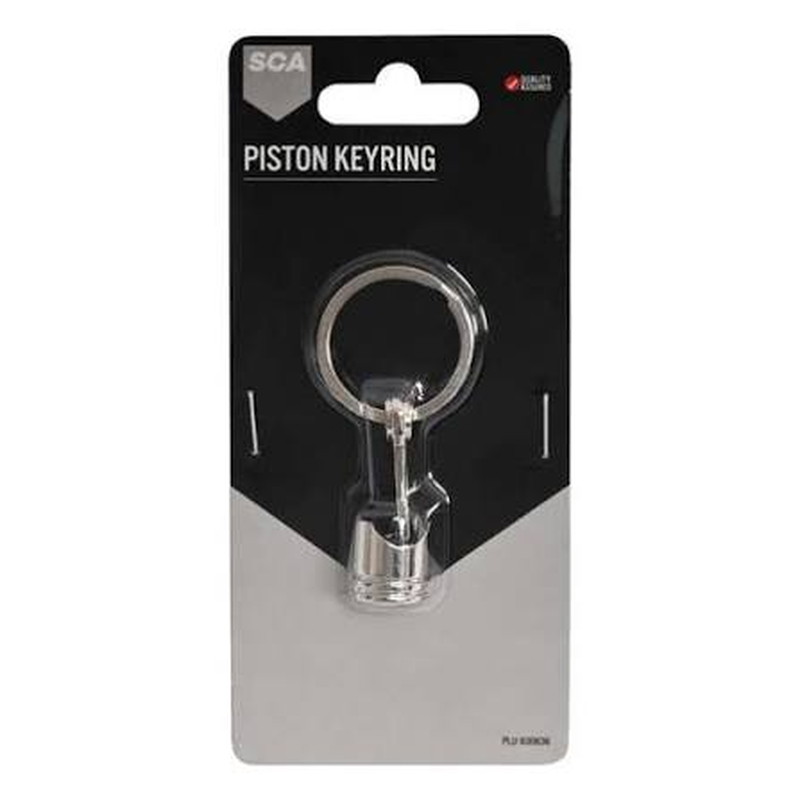 Chrome metal piston keychain on a black and grey retail blister card
