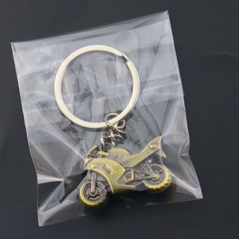 Motorcycle metal keychain sealed in a retail OPP bag with the wing charm