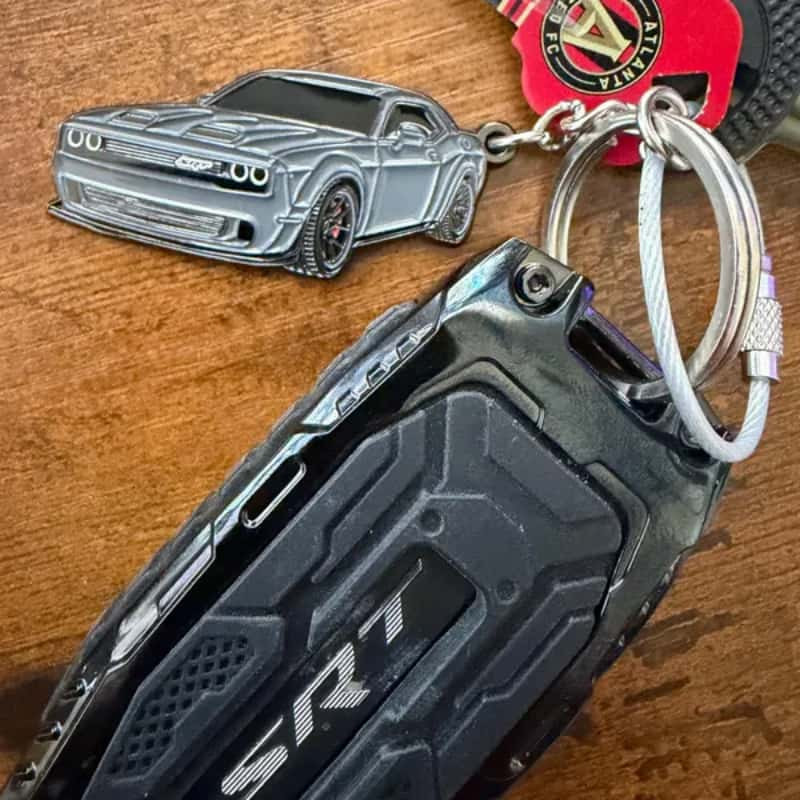 Muscle car keychain: white and black on a wooden desk