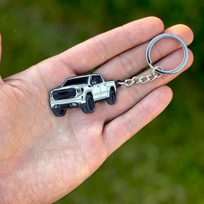Pickup truck keychain: blue pickup held in hand