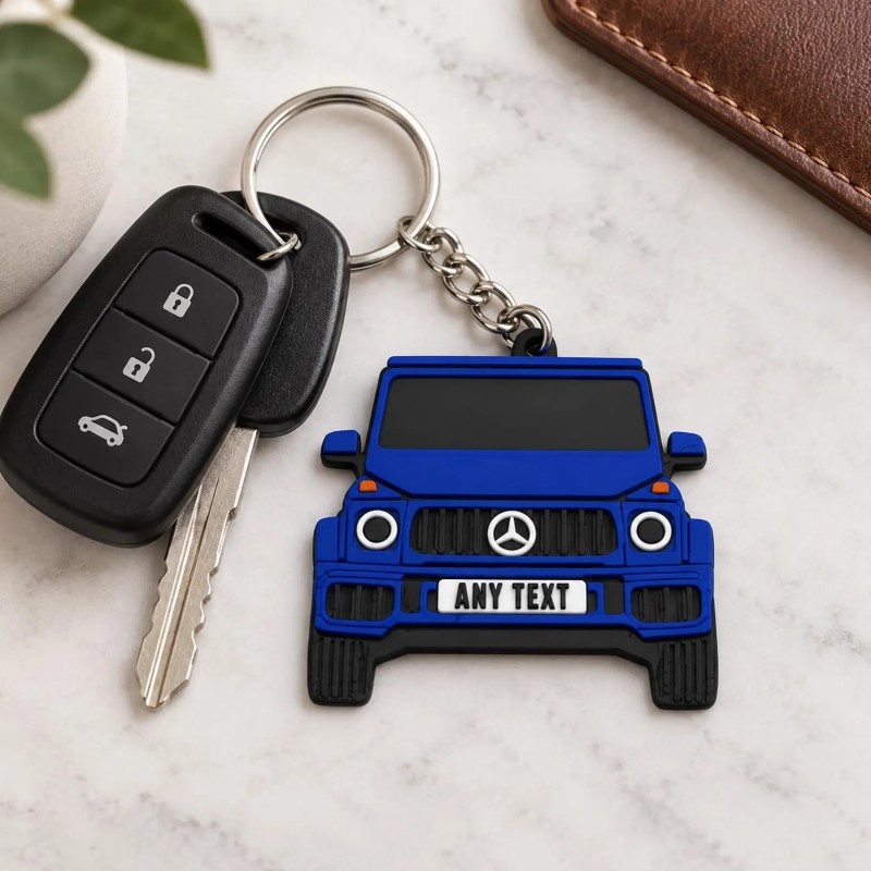 Blue PVC car keychain attached to a car key fob on a marble table