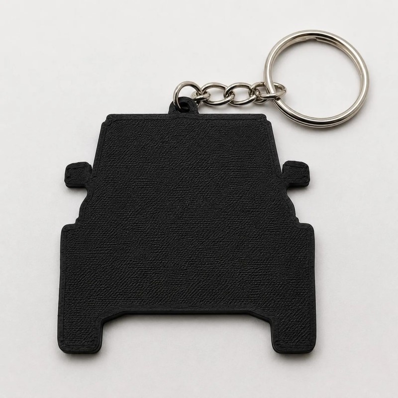 Plain black back of the PVC car keychain with its split ring and twisted chain