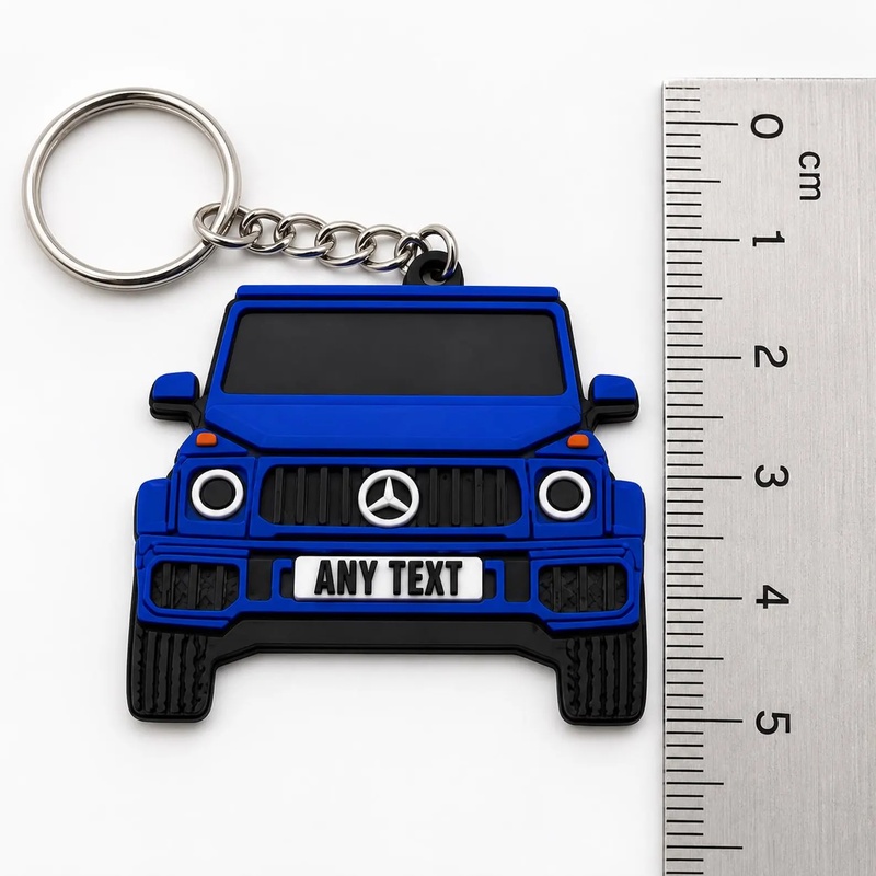 PVC car keychain measured against a ruler: about 5 cm tall with the split ring