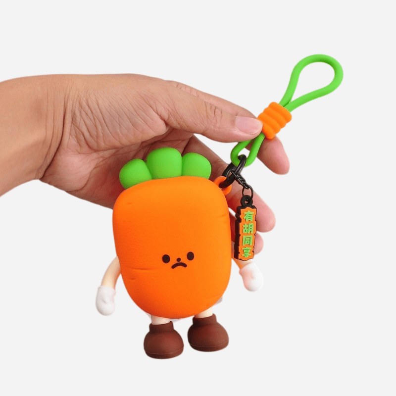 hand holding a carrot shaped silicone coin purse keychain