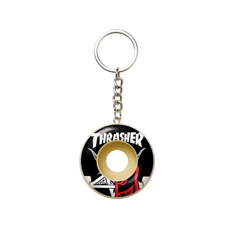 Cream spitfire wheel keychain with a bold black Thrasher-style graphic print and metal chain
